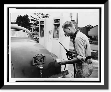 Historic Framed Print, [A Service station attendant measures out gasoline in accordance with the Office of Production Administration's new A gasoline ration books].photo by Liberman., 17-7/8